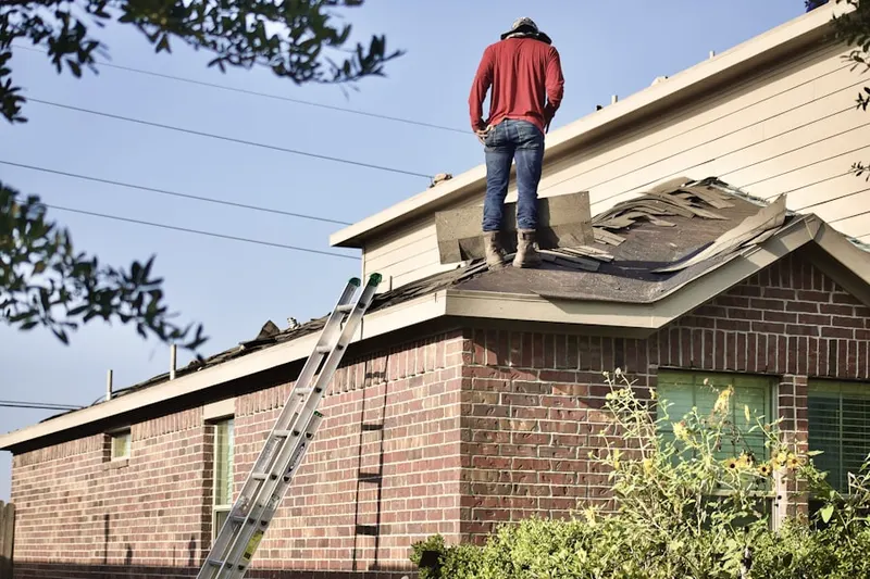Professional roofer working on a residential roof in Harbor Green